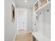 Hallway features wood floors, white walls, and a mudroom with storage at 140 Big Barn Dr, Wendell, NC 27591