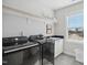 Well-equipped laundry room featuring modern black appliances and ample storage space at 140 Big Barn Dr, Wendell, NC 27591