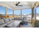 Inviting screened-in porch, perfect for entertaining or relaxing, with comfortable seating and a ceiling fan at 140 Big Barn Dr, Wendell, NC 27591