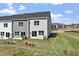 A townhouse backyard with a lawn and bushes and view of neighboring townhomes at 156 Fideaux Blvd # 248, Raleigh, NC 27603