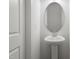A half bathroom with a round mirror, a white pedestal sink and a modern faucet at 156 Fideaux Blvd # 248, Raleigh, NC 27603