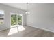 Dining area with a chandelier and sliding glass doors offering bright natural light and outdoor views at 156 Fideaux Blvd # 248, Raleigh, NC 27603