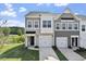 Charming townhouse featuring a gray exterior, a two-car garage, well-maintained landscaping and ample windows at 156 Fideaux Blvd # 248, Raleigh, NC 27603