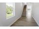 Bright hallway with stairs features modern flooring, a large window with a view, and neutral walls at 156 Fideaux Blvd # 248, Raleigh, NC 27603