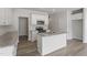 Contemporary kitchen with white cabinets, granite countertops, stainless steel appliances, and center island at 156 Fideaux Blvd # 248, Raleigh, NC 27603