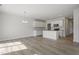 Spacious kitchen with white cabinets, stainless appliances, and island open to the living area at 156 Fideaux Blvd # 248, Raleigh, NC 27603
