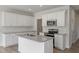 Bright kitchen featuring white cabinets, stainless steel appliances, subway tile backsplash, and a central island at 156 Fideaux Blvd # 248, Raleigh, NC 27603