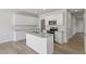 Well-lit kitchen boasts white cabinetry, granite countertops, modern appliances, and a functional island at 156 Fideaux Blvd # 248, Raleigh, NC 27603