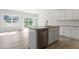 Modern kitchen island features granite countertops, stainless steel appliances, and a large window with views at 156 Fideaux Blvd # 248, Raleigh, NC 27603
