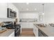 Modern kitchen featuring stainless steel appliances, granite countertops and white cabinets at 156 Fideaux Blvd # 248, Raleigh, NC 27603