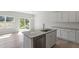 Bright kitchen with a central island, granite countertop, and stainless steel dishwasher at 156 Fideaux Blvd # 248, Raleigh, NC 27603