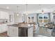 Open concept kitchen with island sink with adjoining dining and living spaces at 156 Fideaux Blvd # 248, Raleigh, NC 27603
