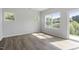 Sunlit living room with hardwood floors, large windows, and a sliding door, filled with natural light at 156 Fideaux Blvd # 248, Raleigh, NC 27603
