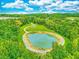 Aerial view of a pond surrounded by walking paths and lush greenery enhancing community appeal at 156 Fideaux Blvd # 248, Raleigh, NC 27603
