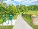 Beautiful walking path with lush greenery and a tranquil pond view, perfect for relaxing strolls at 156 Fideaux Blvd # 248, Raleigh, NC 27603