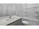 Bright bathroom featuring modern fixtures, including a vanity with a white countertop and a bathtub with shower at 2241 Horton Park Dr, Apex, NC 27539