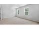 Bedroom with plush carpet and two windows providing natural light at 2241 Horton Park Dr, Apex, NC 27539