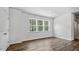 Bright bedroom featuring hardwood floors, a large window with views, and a closet at 2241 Horton Park Dr, Apex, NC 27539