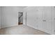 Neutral bedroom with a closet with double doors, beige carpet, and view to stairway at 2241 Horton Park Dr, Apex, NC 27539