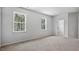 Spacious bedroom with carpet flooring and two large windows at 2241 Horton Park Dr, Apex, NC 27539