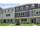 Modern townhouses displaying shades of gray siding and brick foundations set against a sunny sky at 2241 Horton Park Dr, Apex, NC 27539
