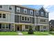 Attractive townhomes showcase a mix of gray tones, complemented by brick detail and green lawns at 2241 Horton Park Dr, Apex, NC 27539
