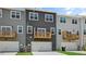 Exterior row of townhomes showcasing individual decks, garage doors, and various paint colors at 2241 Horton Park Dr, Apex, NC 27539