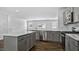 Modern kitchen features gray cabinets, stainless steel appliances, an island, and an open concept layout at 2241 Horton Park Dr, Apex, NC 27539