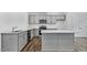 Modern kitchen with stainless steel appliances, a kitchen island, and sleek gray cabinets at 2241 Horton Park Dr, Apex, NC 27539