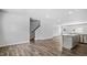 Open concept living space with hardwood floors, a staircase, and a kitchen area at 2241 Horton Park Dr, Apex, NC 27539