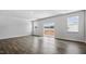 Spacious living room showcasing hardwood floors and sliding glass doors to the balcony at 2241 Horton Park Dr, Apex, NC 27539
