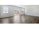 Bright and spacious living area featuring wood floors, large windows, and sliding doors to a deck at 2241 Horton Park Dr, Apex, NC 27539