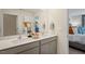 Bathroom with double sink vanity, modern fixtures, and decor, with a glimpse into an adjacent bedroom at 248 Oak Barrel St, Smithfield, NC 27577