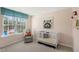 Bedroom featuring a cozy gray armchair, a charming crib, and a bright window showcasing an American flag at 248 Oak Barrel St, Smithfield, NC 27577
