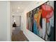 Inviting hallway featuring wood floors and colorful art pieces on the walls at 248 Oak Barrel St, Smithfield, NC 27577