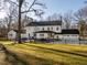 Spacious backyard with a well-maintained lawn, patio, and fenced area, ideal for outdoor living at 2511 Pineway Dr, Burlington, NC 27215
