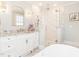 Bathroom featuring white vanity, framed mirror, frameless glass shower and pendant lights at 2511 Pineway Dr, Burlington, NC 27215