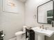 Cozy bathroom featuring brick accent wall, pedestal sink, black vanity, and unique decor at 2511 Pineway Dr, Burlington, NC 27215