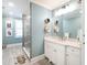 Bright bathroom with modern vanity, marble countertop, walk-in shower, and unique hexagonal shelving at 2511 Pineway Dr, Burlington, NC 27215