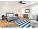Bedroom featuring hardwood flooring, decorative artwork, ceiling fan and plantation shutters at 2511 Pineway Dr, Burlington, NC 27215