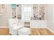 Bedroom with custom shelves, desk, hardwood flooring and white chair at 2511 Pineway Dr, Burlington, NC 27215