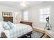 Comfortable bedroom with wood floors, ample natural light, and simple, elegant decor at 2511 Pineway Dr, Burlington, NC 27215