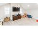 Bonus room featuring a flat screen TV, two windows with shutters, and a cozy teddy bear at 2511 Pineway Dr, Burlington, NC 27215