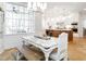 Bright dining area with large windows and rustic dining set, adjacent to the open kitchen at 2511 Pineway Dr, Burlington, NC 27215