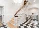 Bright foyer with black and white tile floor, a staircase with wooden banister, and decorative details at 2511 Pineway Dr, Burlington, NC 27215