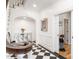 Elegant foyer with a black and white marble floor, curved staircase, mirrored console table, and stylish decor at 2511 Pineway Dr, Burlington, NC 27215
