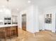 Bright kitchen featuring white cabinetry, stainless steel appliances, and hardwood herringbone floors at 2511 Pineway Dr, Burlington, NC 27215