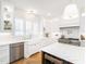 Bright, white kitchen featuring custom cabinets, stainless steel appliances, a large island and stylish light fixtures at 2511 Pineway Dr, Burlington, NC 27215