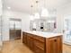 Gourmet kitchen features a large island with bar seating, a Sub-Zero fridge, and herringbone hardwood floors at 2511 Pineway Dr, Burlington, NC 27215