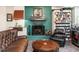 Cozy living room with fireplace, golf gear display, leather sofa and arm chair at 2511 Pineway Dr, Burlington, NC 27215
